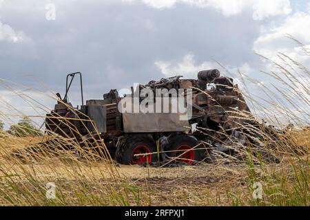 Burnt-out combine harvester, Steinbergkirche, Steinberg, Schleswig-Holstein, Germany Stock Photo