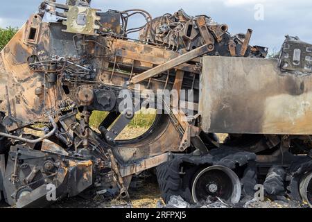 Burnt-out combine harvester, Steinbergkirche, Steinberg, Schleswig-Holstein, Germany Stock Photo