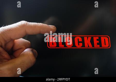 index finger pointing at a locked digital screen Stock Photo