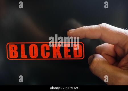 index finger pointing at a locked digital screen Stock Photo