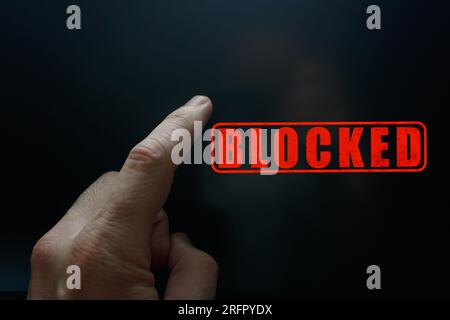 index finger pointing at a locked digital screen Stock Photo