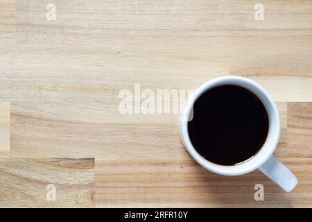 Wooden background with a blurred cup of coffee on it Stock Photo
