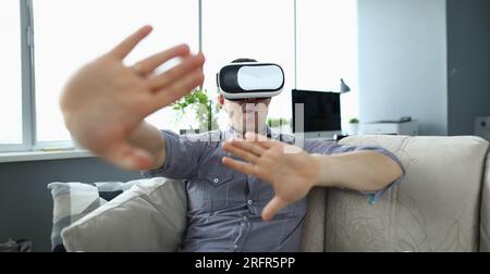 Close-up view of young man watching realistic picture in virtual reality headset Stock Photo