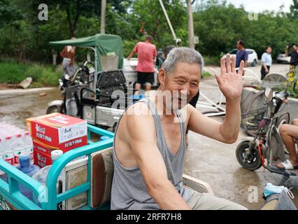 Beijing, China. 05th Aug, 2023. (230805) -- BEIJING, Aug. 5, 2023 (Xinhua) -- A villager who has been evacuated to a settlement site prepares to return to his home after receiving relief supplies in Koutou Village of Qinglonghu Town in Fangshan District of Beijing, capital of China, Aug. 5, 2023. As this round of typhoon-induced torrential rains have come to an end in Beijing, some villagers of Fangshan District, who had been evacuated to settlement sites due to heavy rainfall over the previous few days, returned home on Saturday after experts assessed the safety of their residences.   Beijing Stock Photo