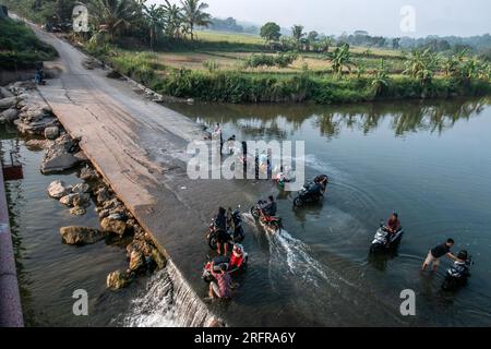 Bogor, Indonesia - August 05, 2023: Activities of residents in Bogor, washing clothes and motorbikes in the River Stock Photo