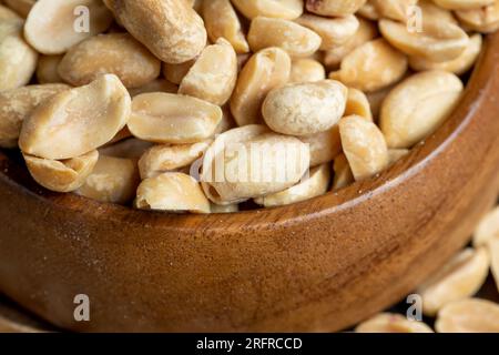 Peeled and roasted peanuts on the table, a pile of whole and half roasted peanuts Stock Photo