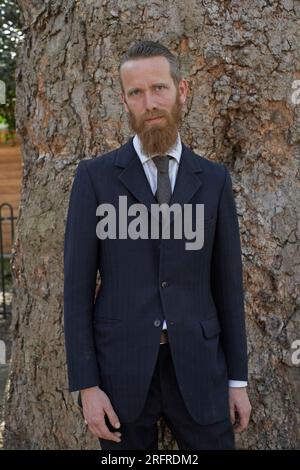 bearded man in suit outdoors. Stock Photo