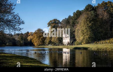 Autumn reflection of the abbey ruins in Painshill Park, Cobham, Surrey, UK in 2023 Stock Photo