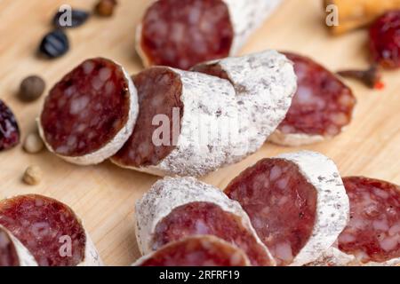 Chunks of sliced sausage with white mold, delicious and fresh Italian sausage in white edible mold Stock Photo