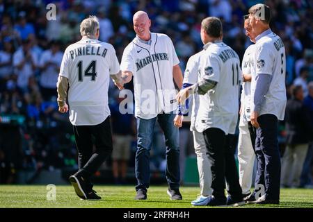 Former Seattle Mariners manager Lou Piniella, left, greets former Mariners  pitcher Jeff Nelson as former designated hitter Edgar Martinez (11) and  first baseman John Olerud, right, look on before the MLB All-Star
