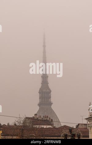 Dome and spire of the Mole Antonelliana shrouded in fog, built between 1863 and 1889, 166 meters high, city symbol of Turin, Piedmont, Italy Stock Photo