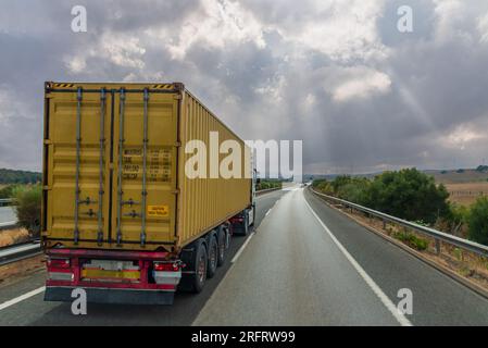 Truck with a container for intermodal transport driving on the highway. Stock Photo
