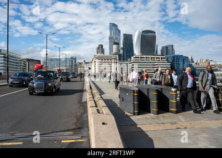 London, England, UK, 31st July 2023. City of London during the evening rush hour as commuters make their way across London Bridge with London's iconic Stock Photo