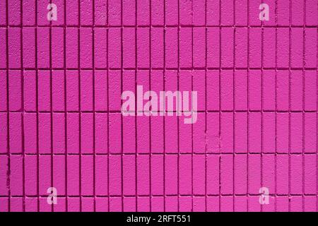 Background from a wall made of rectangular pink mosaic tiles Stock Photo
