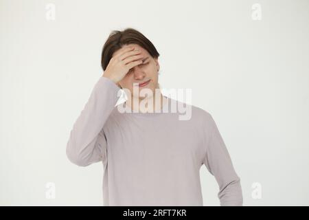 Portrait of young man holding his hand with his head Stock Photo