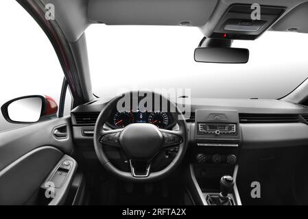 Photo from the perspective of a driver in a modern passenger car, capturing the view of the steering wheel, front windshield, dashboard, gear shift, s Stock Photo