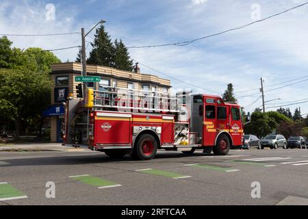 A fire engine from Fire Station 29 responds to an emergency along SW Admiral Way in Seattle’s affluent North Admiral neighborhood. Stock Photo