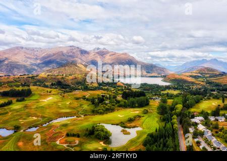 Arrowtown town in New Zealand near Queenstown in scenic mountain region with valleys and lake Hayes. Stock Photo