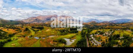 Arrowtown town in scenic vale of New Zealand South Island at Lake Hayes near QUeenstown- aerial panorama. Stock Photo