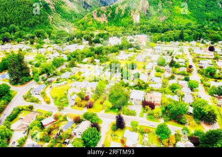 Arrowtown historic village in scenic mountain vale of NEw Zealand - aerial view. Stock Photo