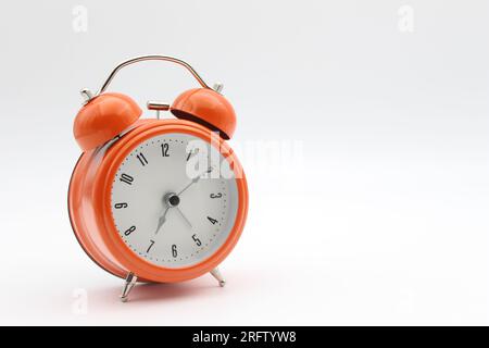 Orange color alarm clock with white background, front view Stock Photo