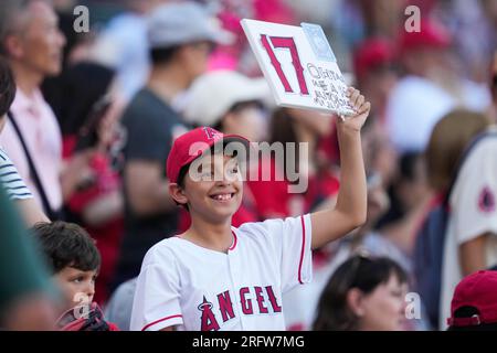 Seattle Mariners fans stand next to a Believe sign during a baseball game  against the Oakland Athletics, Wednesday, Sept. 29, 2021, in Seattle. Fans  and the team have adopted the one-word slogan