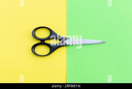 Scissors placed on colored papers, after some edits. Stock Photo