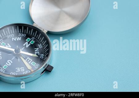 A compass isolated on blue background, after some edits. Stock Photo