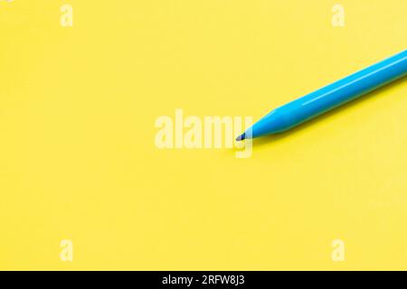 Blue marker isolated on yellow background, after some edits. Stock Photo