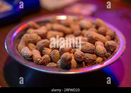 Bowl of peanuts on a bar top Stock Photo