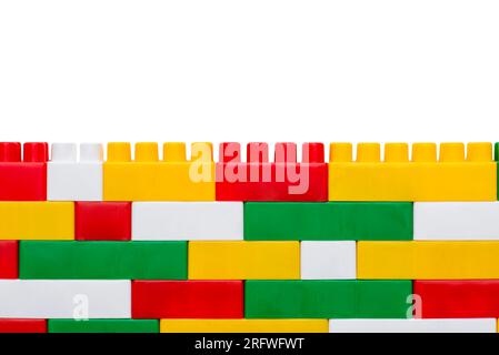Wall from plastic blocks. Plastic building blocks isolated on white background Stock Photo
