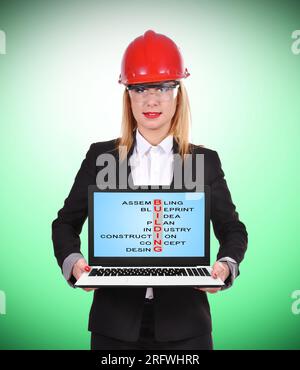woman engineer holding pc with  crossword on construction Stock Photo