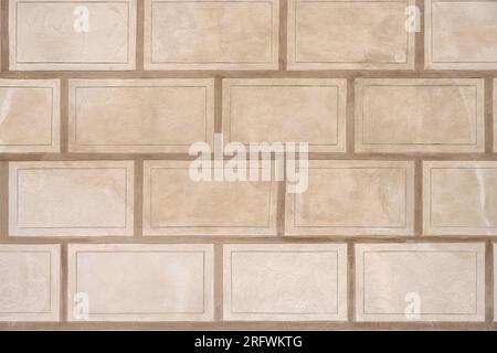 Background from a wall with rectangular beige stone slabs Stock Photo