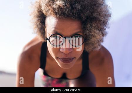 focused sportswoman in position to start a race Stock Photo