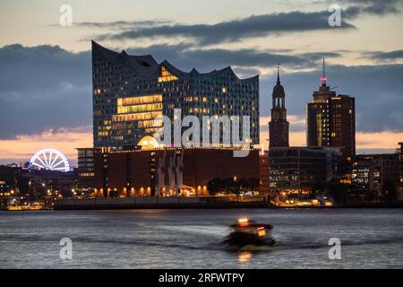 Hamburg: Elbphilharmonie, Michel and Ferry Wheel of the Hamburger Dom in the evening, seen from the Schuppen 52 southern of the Elbe river Stock Photo