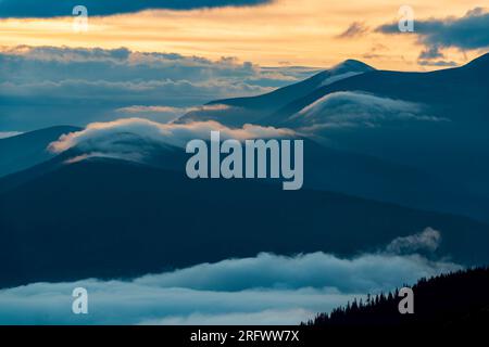 Rolling hills and foggy valleys in Carpathian mountains. Scenic outdoor landscape Stock Photo
