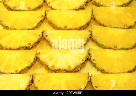 Pineapple juicy yellow slices as a background. Top view. Stock Photo