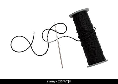 Plastic spool with black synthetic threads close-up. Needle and thread Stock Photo