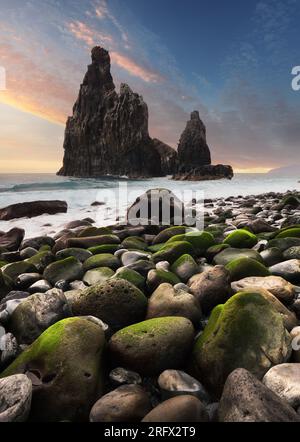 Beautiful scenery seascape of Atlantic ocean. Stunning summer sunrise on Ilheu da Ribeira da Janela rock formation. Colorful summer scene of Madeira, Stock Photo