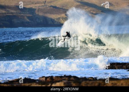 Surfer on crest of wave Stock Photo