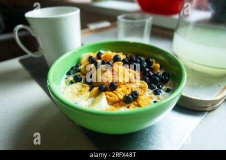 Close up of a bowl of cornflakes with blueberries and banana in milk Stock Photo