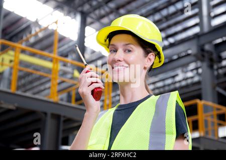 Female industrial worker using radio on site Stock Photo - Alamy