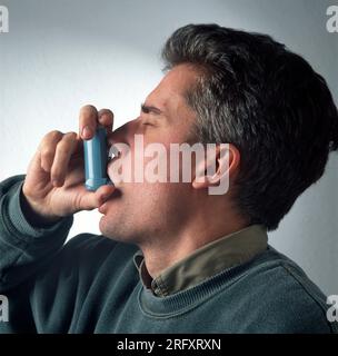 Man using inhaler Stock Photo