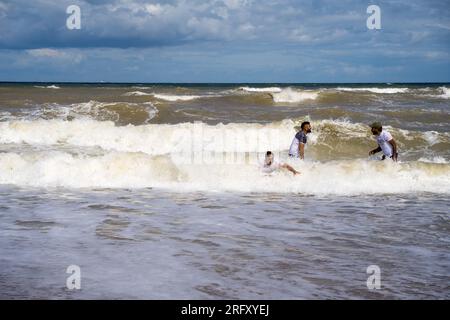 Kent UK. 06th August 2023. UK Weather. Strong  winds can be felt and choppy sea water seen at Kent south coast while Storm Antoni hits England' south west coast with near-80mph gusts. People still enjoying sunny day on beach swimming in incoming waves. Credit: xiu bao/Alamy Live News Stock Photo