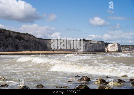 Kent UK. 06th August 2023. UK Weather. Strong  winds can be felt and choppy sea water seen at Kent south coast while Storm Antoni hits England' south west coast with near-80mph gusts. People still enjoying sunny day on beach swimming in incoming waves. Credit: xiu bao/Alamy Live News Stock Photo