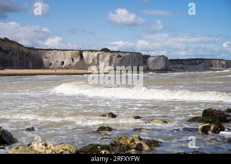 Kent UK. 06th August 2023. UK Weather. Strong  winds can be felt and choppy sea water seen at Kent south coast while Storm Antoni hits England' south west coast with near-80mph gusts. People still enjoying sunny day on beach swimming in incoming waves. Credit: xiu bao/Alamy Live News Stock Photo