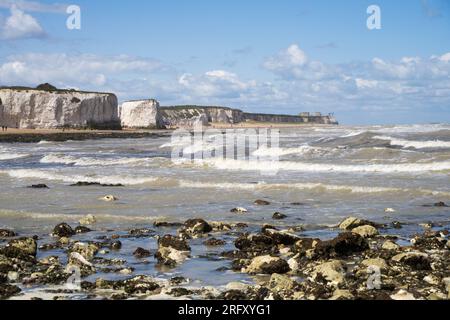 Kent UK. 06th August 2023. UK Weather. Strong  winds can be felt and choppy sea water seen at Kent south coast while Storm Antoni hits England' south west coast with near-80mph gusts. People still enjoying sunny day on beach swimming in incoming waves. Credit: xiu bao/Alamy Live News Stock Photo