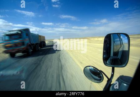 a Tourist Tour with Cars in the Landscape and Nature in the White Desert near the Village of Farafra in the Libyan or western desert of Egypt in North Stock Photo