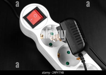 Failure to connect different incompatible American electrical plug and  European splitter socket in travel close up Stock Photo