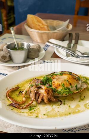 Grilled cuttlefish or choco dish in the traditional Canarian restaurant on Tenerife island, Spain. Stock Photo